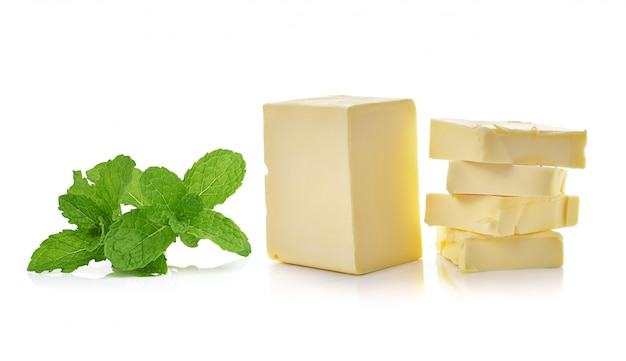 mint and stick of butter isolated on white space