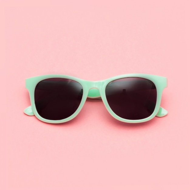 Photo mint sunglasses isolated on pink background.