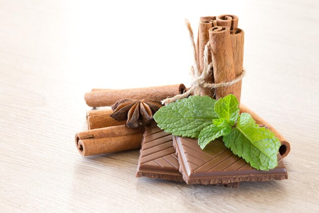 Mint with cinnamon on wood background