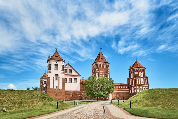 Mir castle complex in summer day with blue cloudy sky