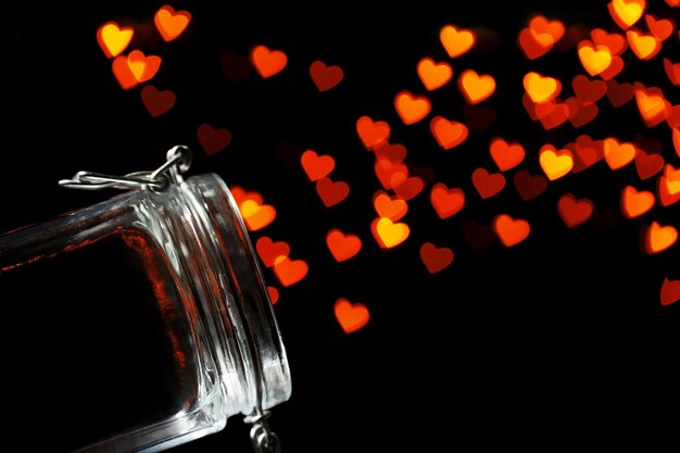 Miracle of love from glass jar on black background