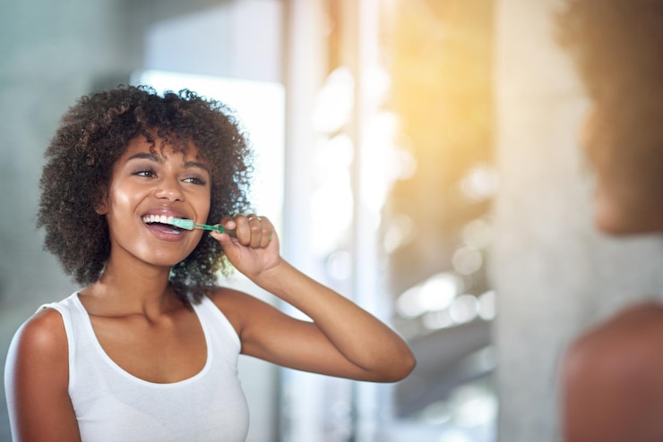 Photo mirror dental and black woman brushing teeth fresh breath and oral health in the bathroom female person happy model and lady with wellness mirror and hygiene with morning routine and tooth care