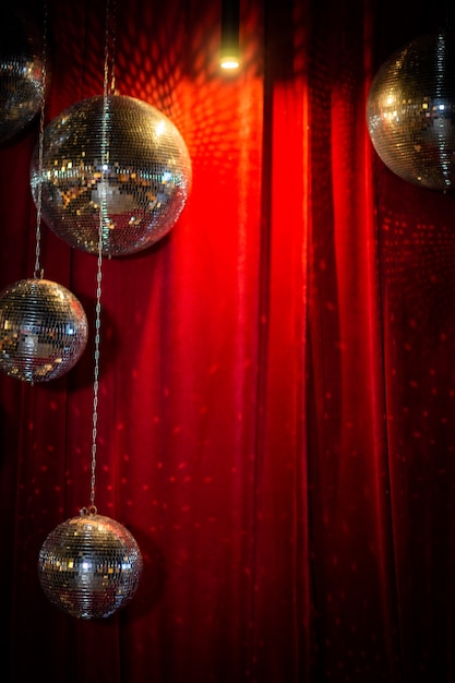 Mirror disco balls against the background of a red velvet curtain