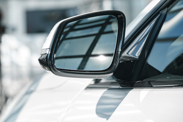 Photo mirror of a new white luxury car close up