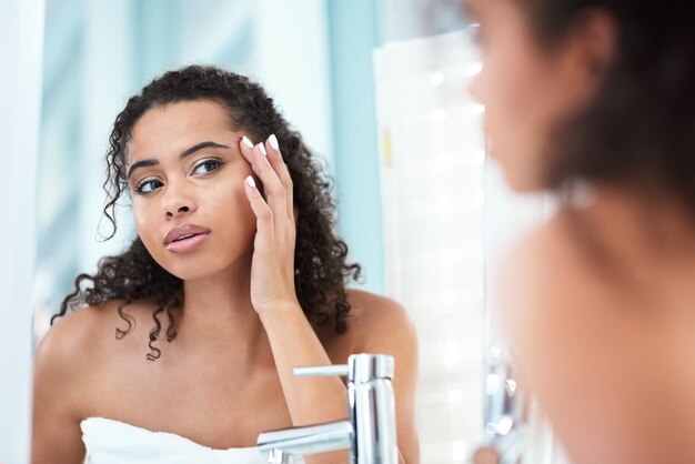 mirror woman and hand in bathroom for skincare beauty and wellness for morning reflection female person and calm for dermatology glow and cosmetics for shine or routine in home or apartment