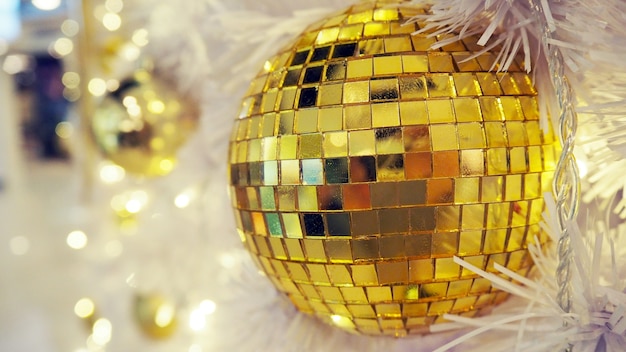 Mirrored disco ball and Christmas decorations on a white background.