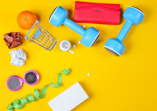 Miscellaneous shopping items on yellow table. Top view.