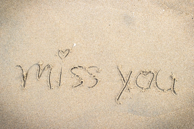 Miss you handwritten in sand for natural symboltourism or conceptual designs