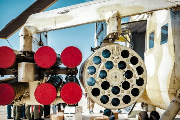 Missile launcher under wing of military helicopter.