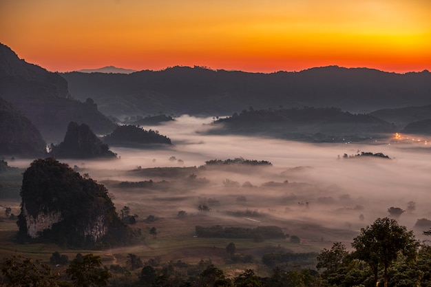 Mist covering valley at dusk