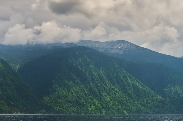 Mist in de ochtendmist van de bergvallei over het meer in het altai-gebergte