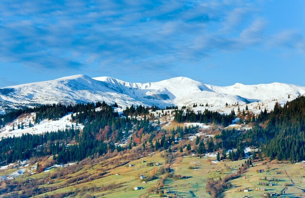 Misty early daybreak in autumn Carpathian mountain, Ukraine (Jasynja Village and Svydovets Range in far)