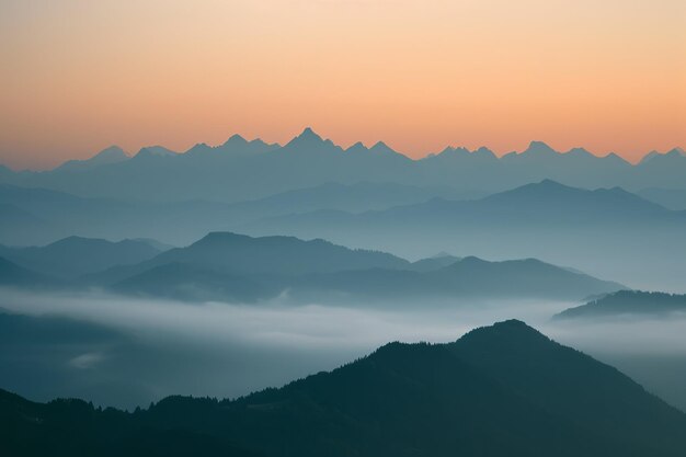 Misty mountain layers at sunrise with a gradient sky