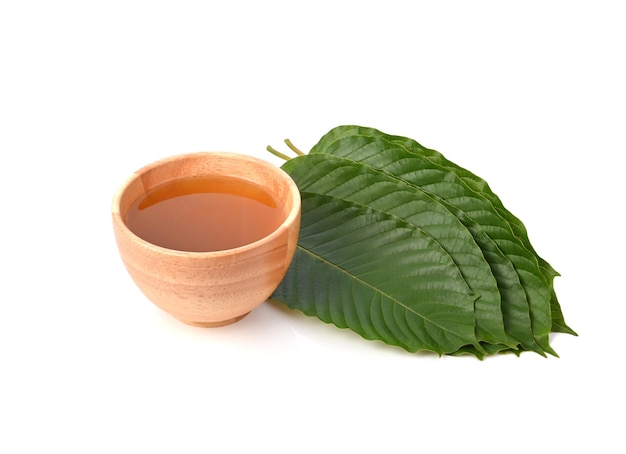 Mitragyna speciosa water in wooden bowl isolated on white background