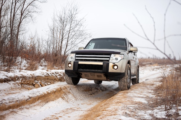 Mitsubishi Pajero Montero at dirt road in winter