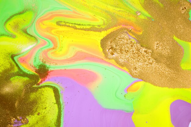 Mix of acrylic vivid colorful inks with gold dust