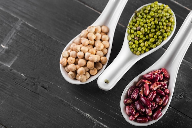 Mix of beans on wooden table