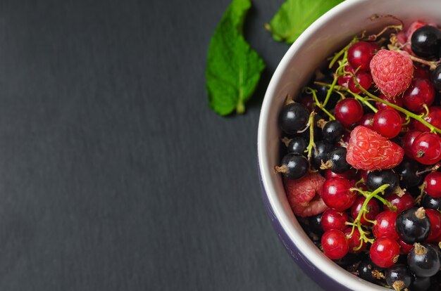 Mix of berries on dark surface.