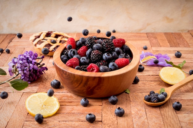 Mix of blueberries, blackberries and raspberries in a wooden bowl