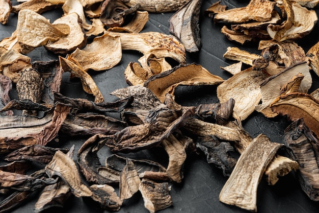 Mix of chopped wild dried mushrooms set, on black table