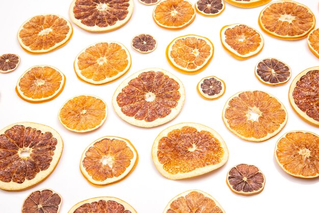 Mix of different pieces of dried citrus fruit on white background