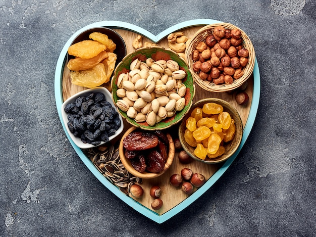 Mix dried fruits and nuts on gray surface. Top view of superfoods.