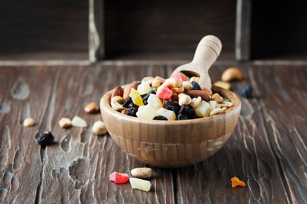 Mix of dried nuts and fruits on the wooden table