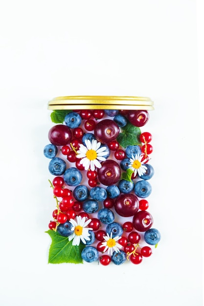 Mix of fresh berries in the form of a jar Flat lay white background
