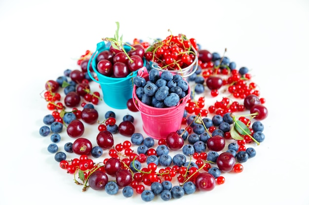 Mix of fresh berries in small buckets