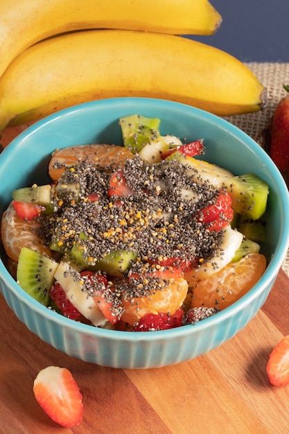 Mix of fresh fruits salad with chia seed and honey. Healthy food concept.