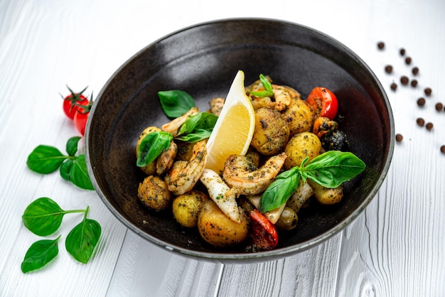 Mix of fresh seafood squid shrimp mussels and clams accompanied by salad and country style fries