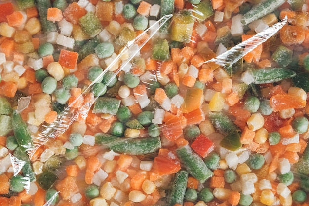 Mix of frozen vegetables in a transparent plastic package. Top view. Copy, empty space for text