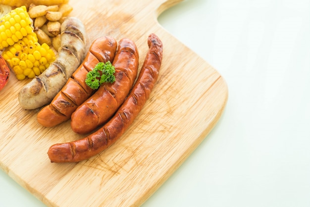 mix grilled sausage with vegetables and french fries
