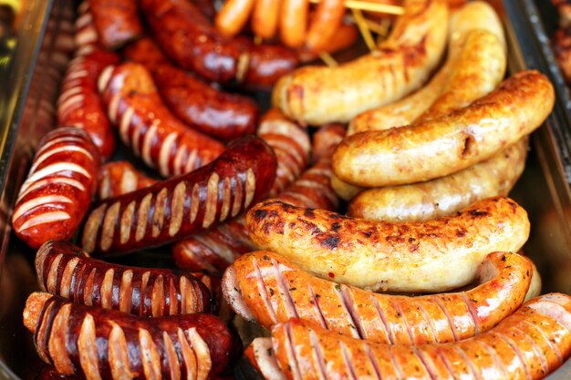 Mix grilled sausages on pan with spices, outside.