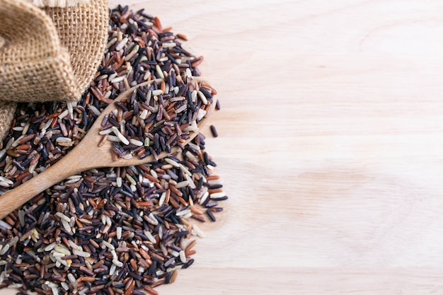 Mix healthy rice on a wooden spoon and sack.