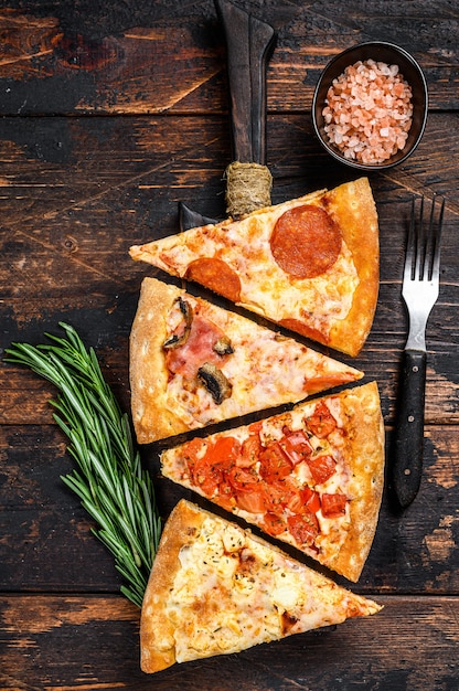 Mix of Italian pizza on a wooden cutting board