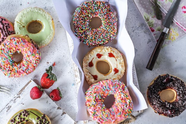 Mix of multicolored sweet donuts with colored sprinkles