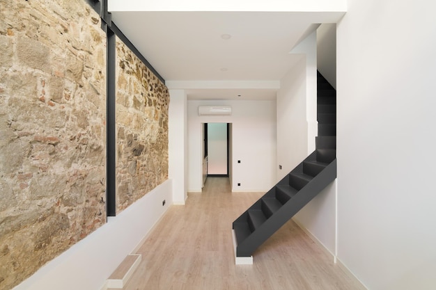 Mix of new and old architecture of barcelona refurbished apartment with restored ancient wall left f...