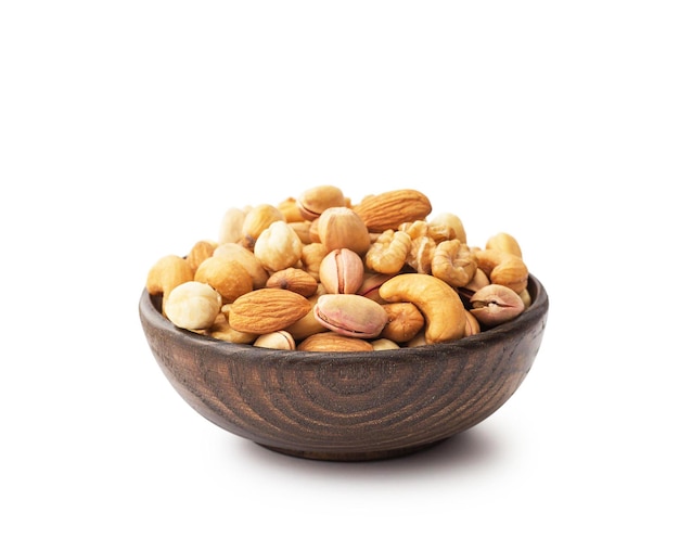 Mix nuts with wooden bowl isolated on white