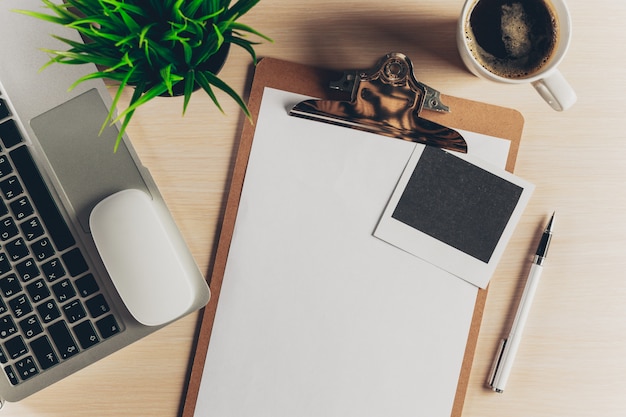 Mix of office supplies and gadgets on wood