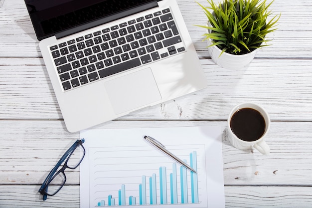 Mix of office supplies and gadgets on a wooden table