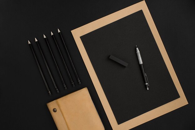 Mix of office supplies on a modern office desk. Object on a black background. Top view. Still life. Copy space