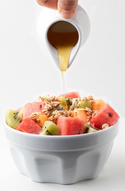 Mix of salad fruits with honey Healthy food concept