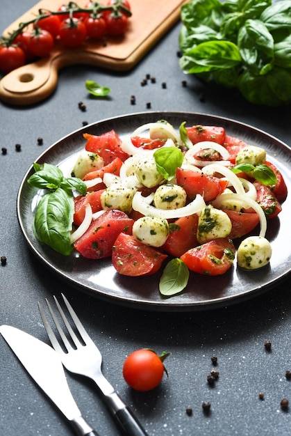 Mix salad with mozzarella tomatoes and pesto sauce Caprese appetizer with pesto