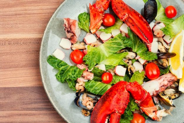 Mix of salad with seafood on plate top view