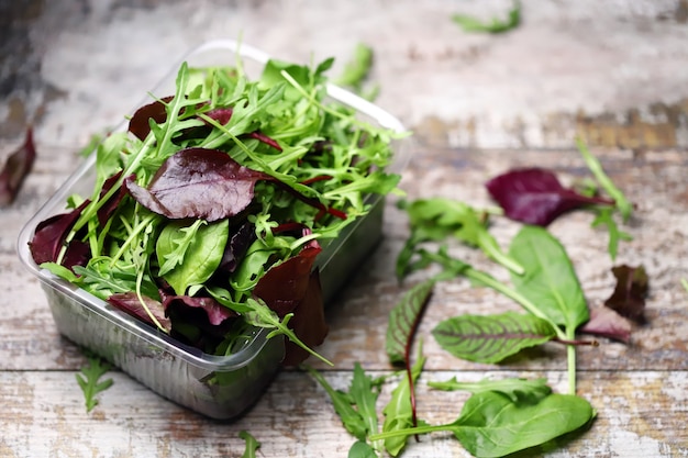 Mix of salads in a plastic container.