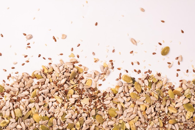 Mix of seeds for a salad A pile of mixed seeds isolated on a white background