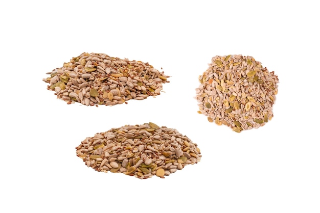 Mix of seeds for a salad A pile of mixed seeds isolated on white background