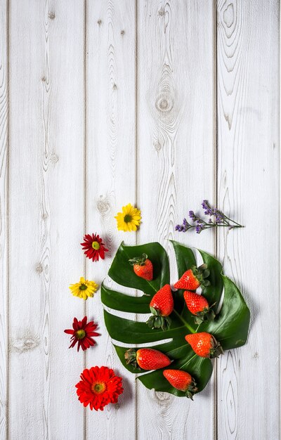 Mix of strawberries and blueberries with flowers