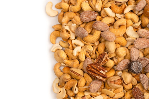 Mix of tasty salty nuts A group of almonds pistachios walnuts macadamia cashews